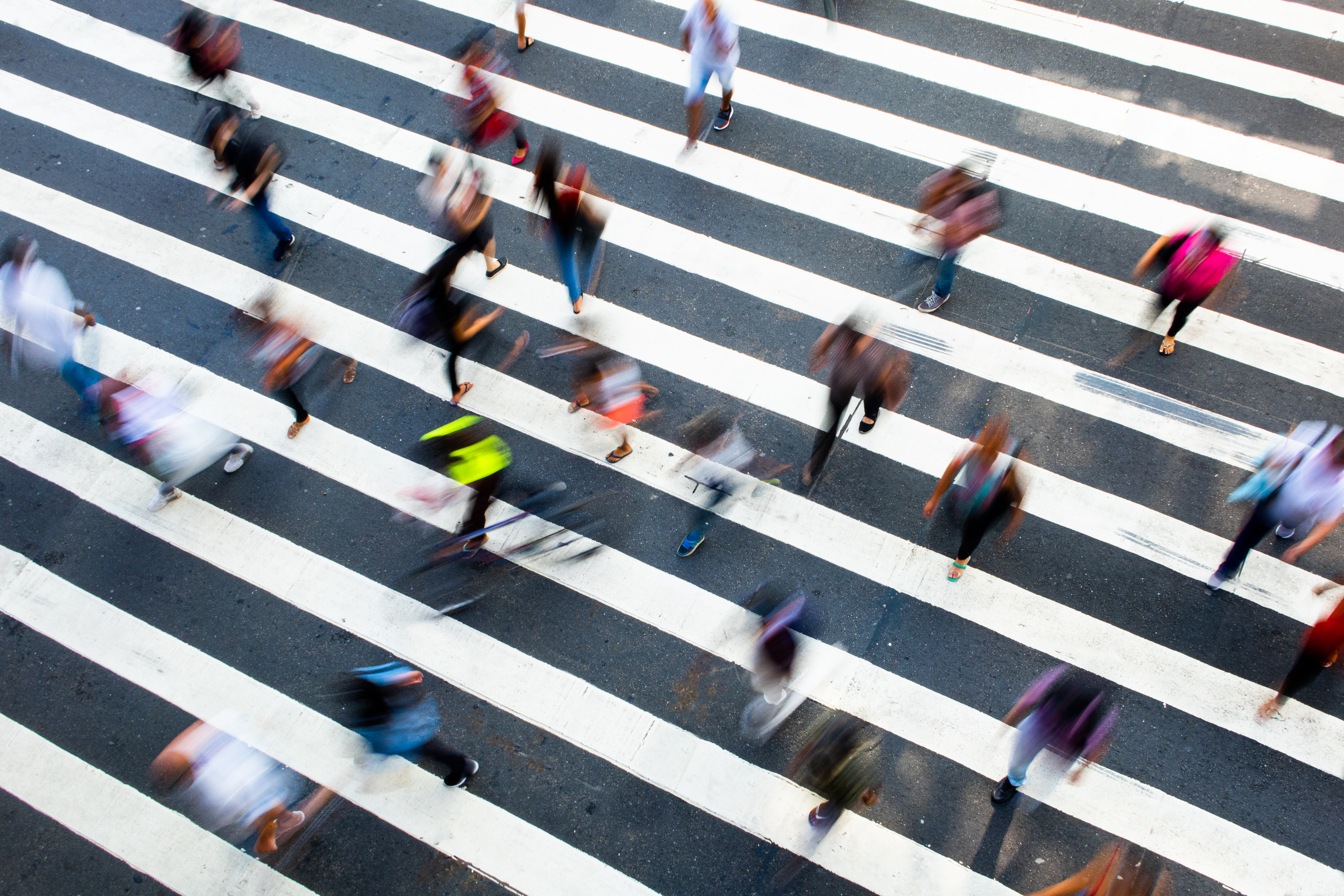 A busy crosswalk with pedestrians in motion