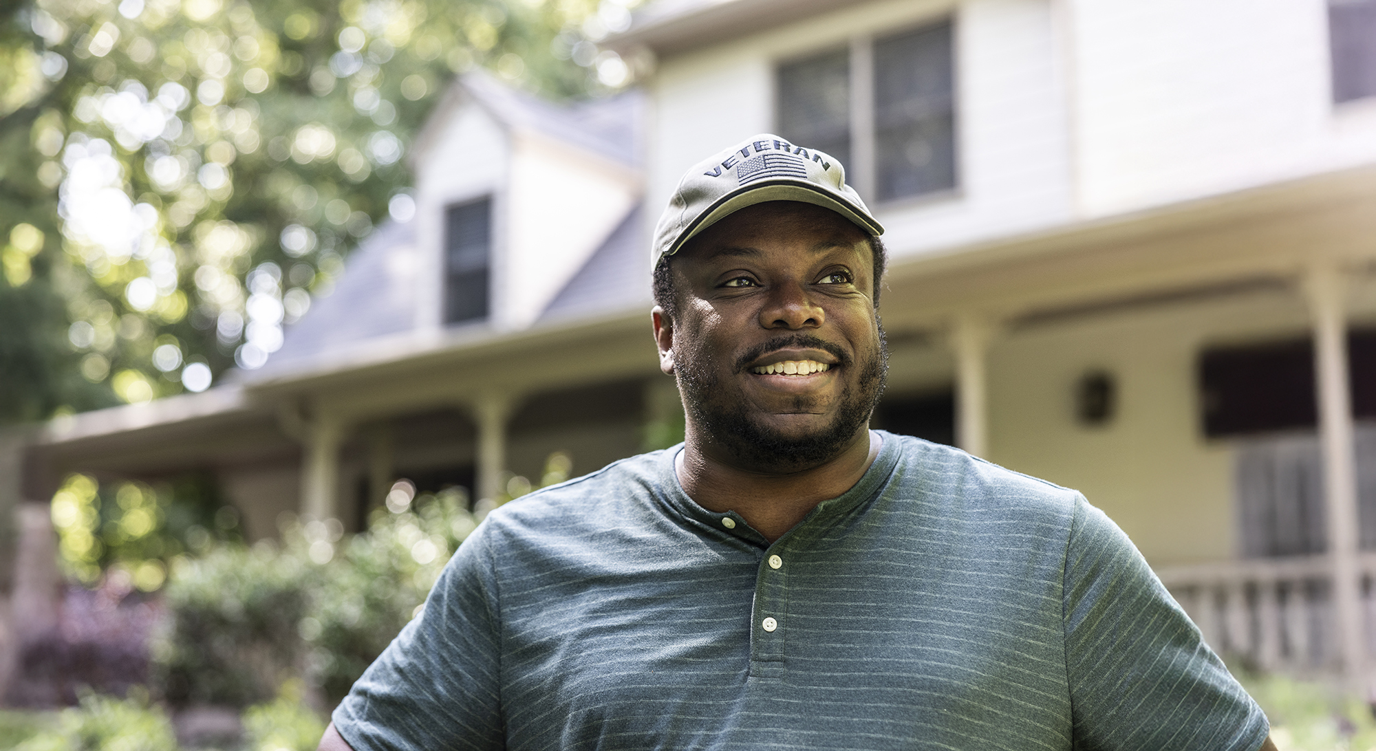 Portrait of U.S. military veteran in front of home